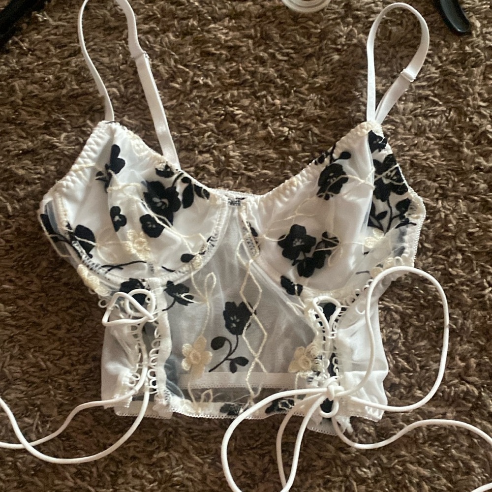 White lace crop top with thin adjustable straps and adjustable side strings.
